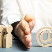 wooden figures and "@" to denote technology, with hand (White) dividing them
