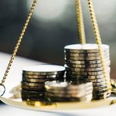 coins balancing on a scale