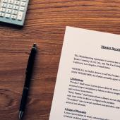 Photo of a pen and a master service agreement. 