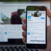 the Twitter application open on a phone and a computer