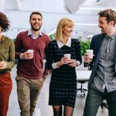 4 business people walking and talking