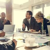 a diverse group of business people discussing around a table