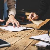 several documents being discussed around a table