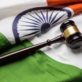 a gavel and the flag of India